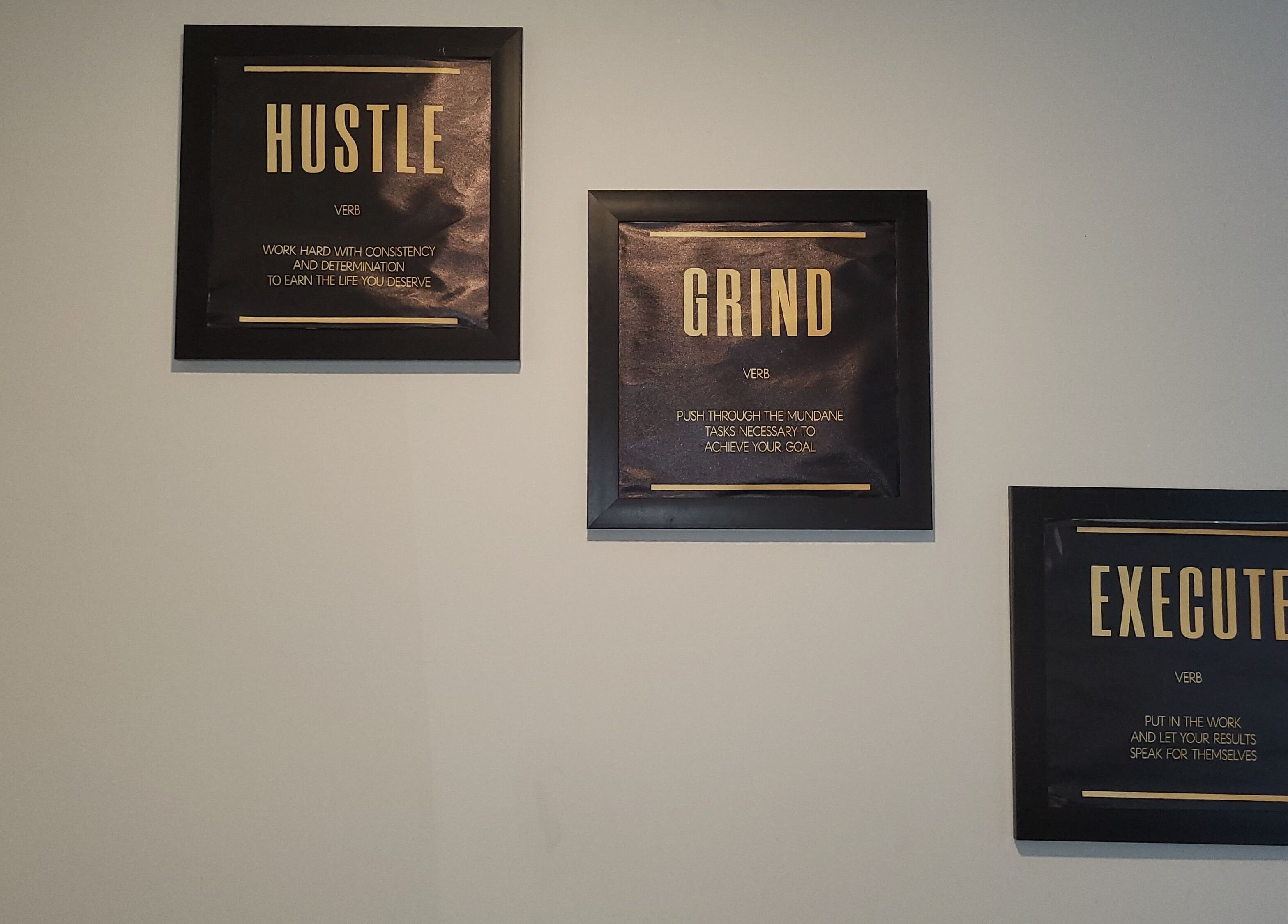 Motivational wall art at Exquisite Salon and Barbershop in Hamilton, Ontario, CA featuring Hustle, Grind, Execute.