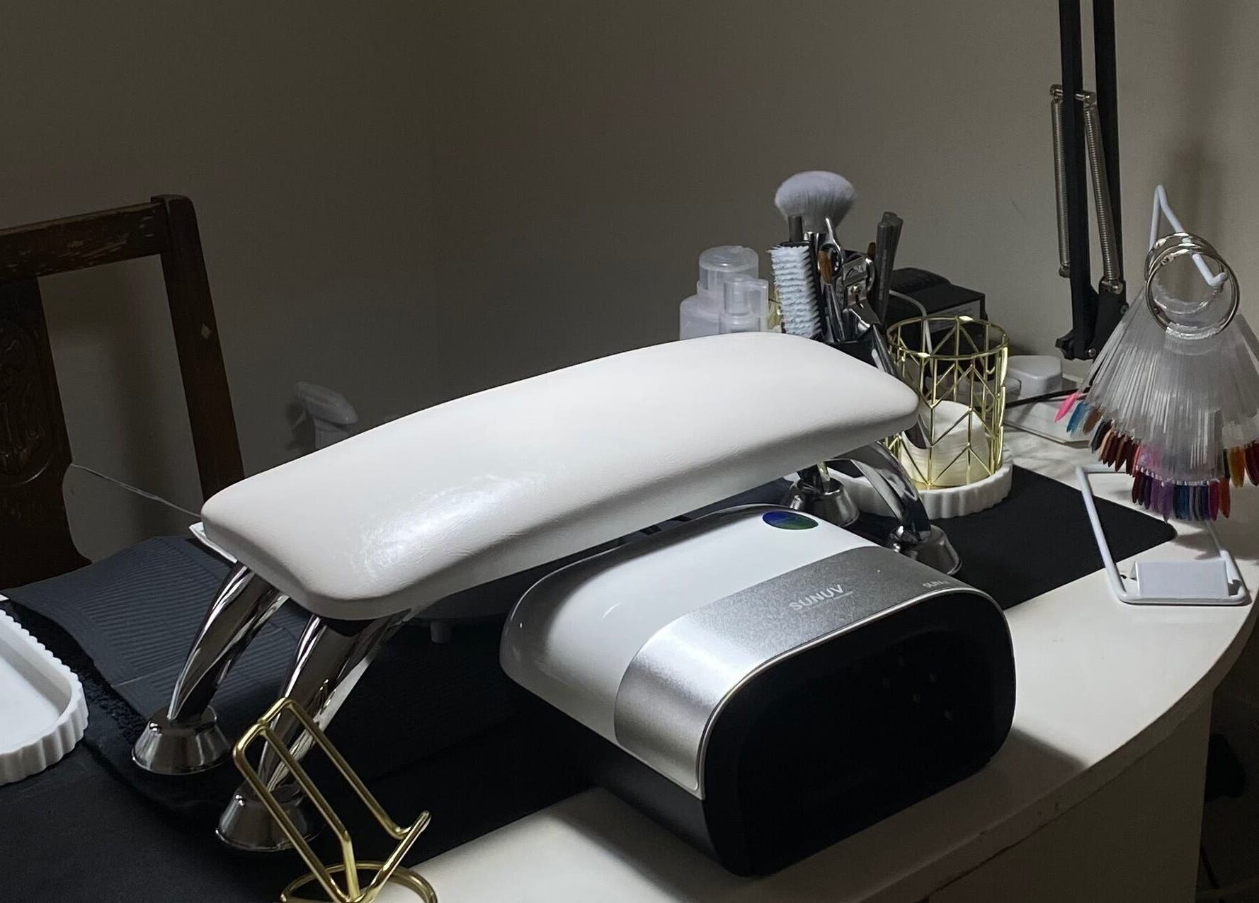 Manicure station at Mayasnailstudiox in Llay, Wales, GB with tools and polishes.