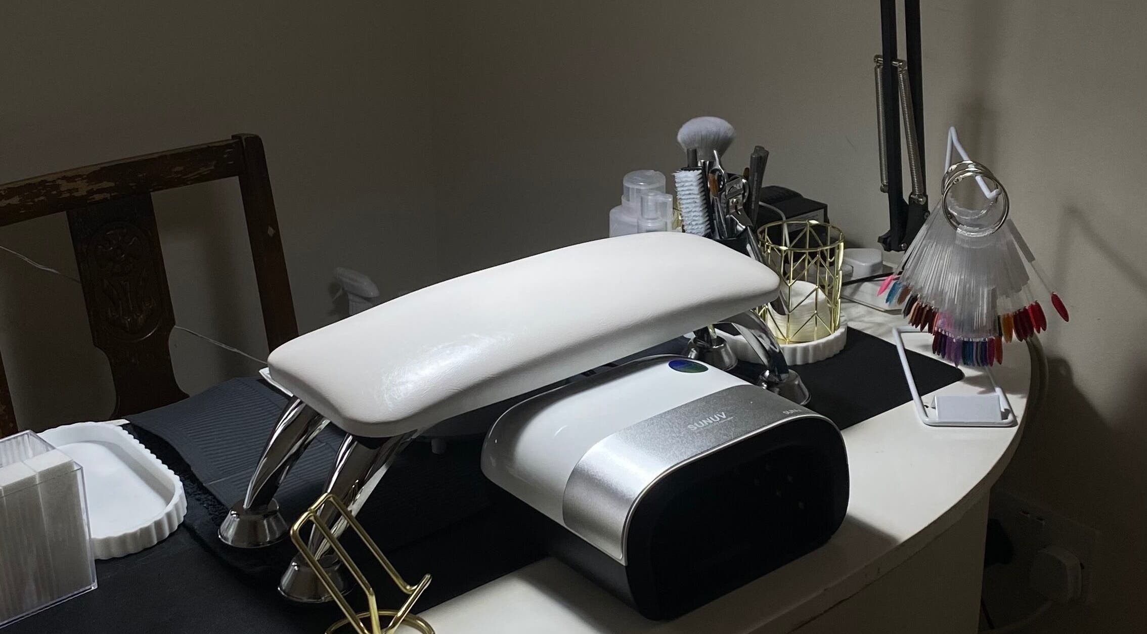 Manicure station at Mayasnailstudiox in Llay, Wales, GB with tools and polishes.