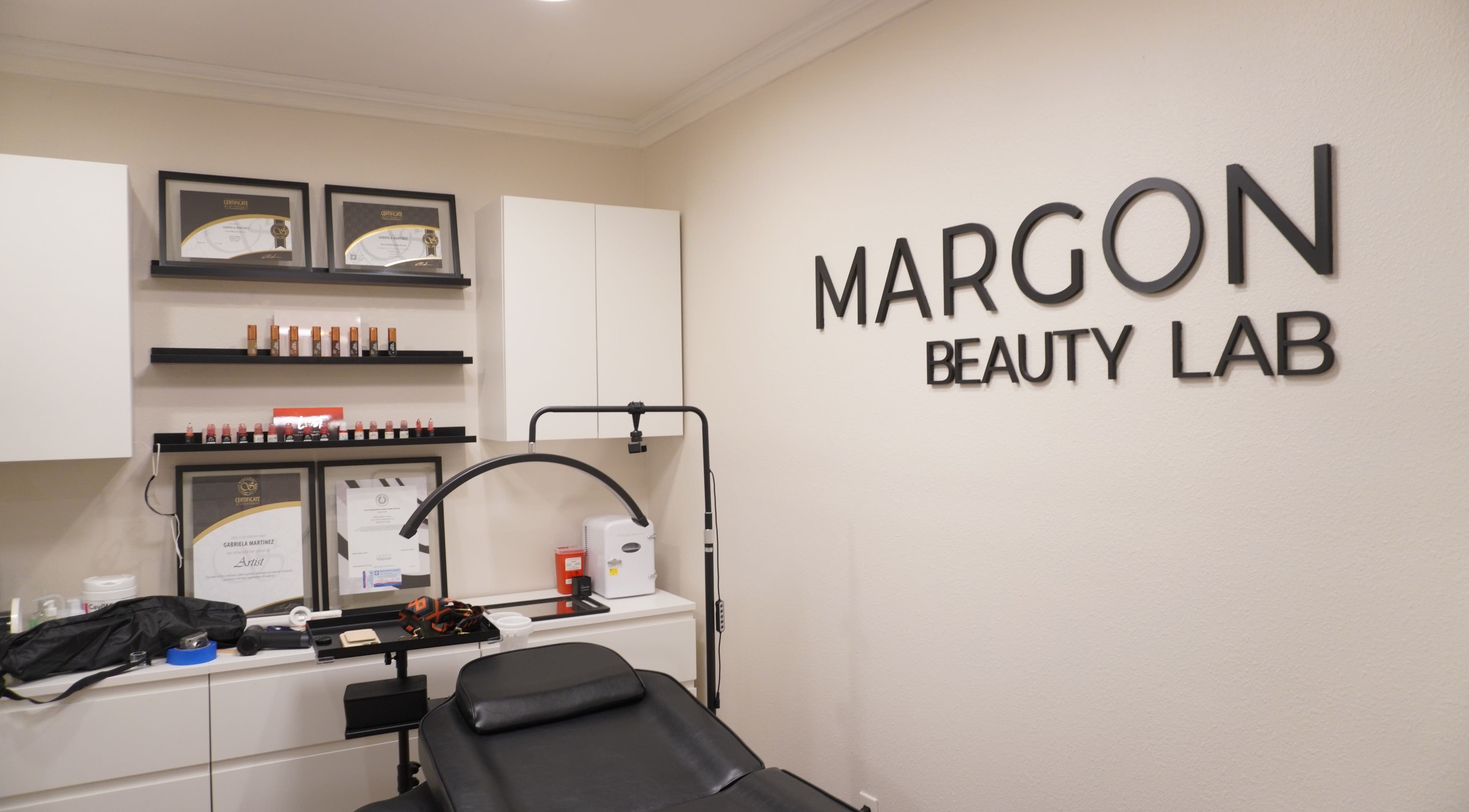 Interior of MARGON BEAUTY LAB in Houston, Texas, showcasing treatment room with certifications displayed.