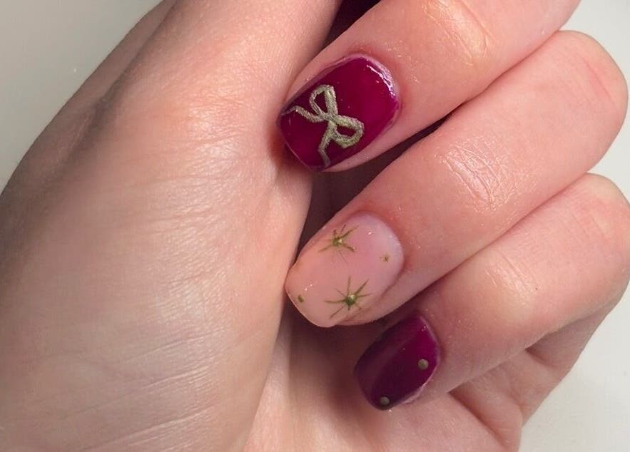 Elegant nail art with red and gold design at PolishedbyChantelle, Pembroke Dock, Wales, GB.