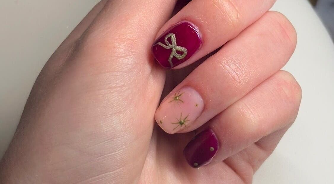 Elegant nail art with red and gold design at PolishedbyChantelle, Pembroke Dock, Wales, GB.