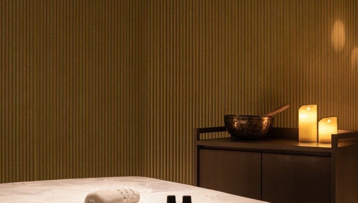 Relaxing candlelit massage room at Glow Haus in Montgomery, Alabama, US, featuring soothing ambience.