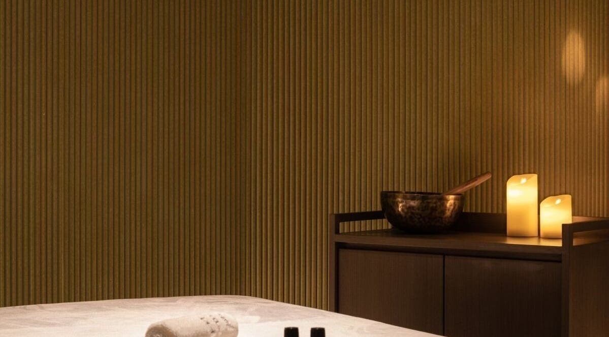 Relaxing candlelit massage room at Glow Haus in Montgomery, Alabama, US, featuring soothing ambience.