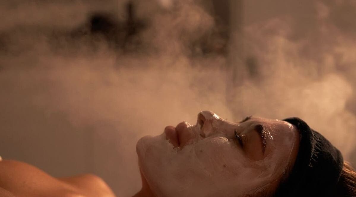 Facial treatment at Glow Haus, Montgomery, Alabama, US, with steam enhancing skincare relaxation.