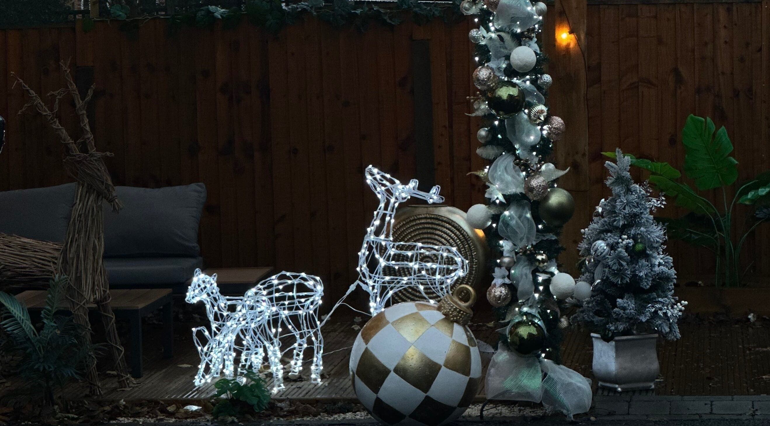 Cozy outdoor festive decor at The Nail Haven, Nottingham, England, GB, featuring lit reindeer and ornaments.
