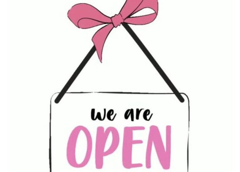 "We are open" sign for The Barbie Effect, Kingstown, St. George, VC, featuring a pink ribbon.