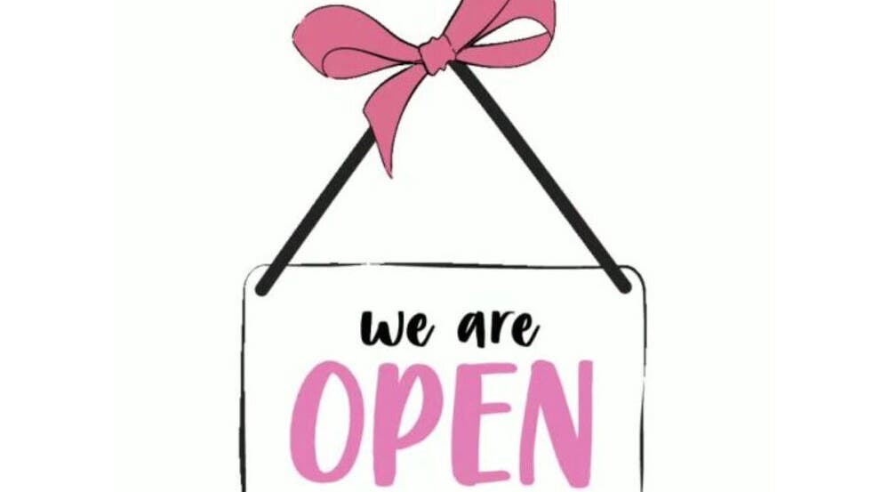 "We are open" sign for The Barbie Effect, Kingstown, St. George, VC, featuring a pink ribbon.