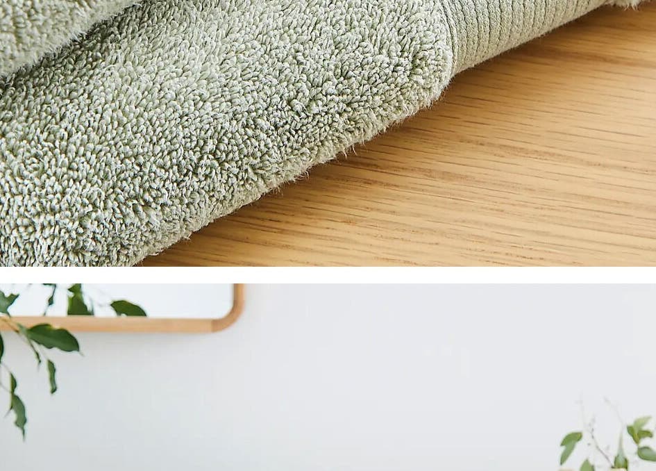 Soft green towels on wooden table at Kate’s massage in Castleford, England, GB, creating a tranquil atmosphere.