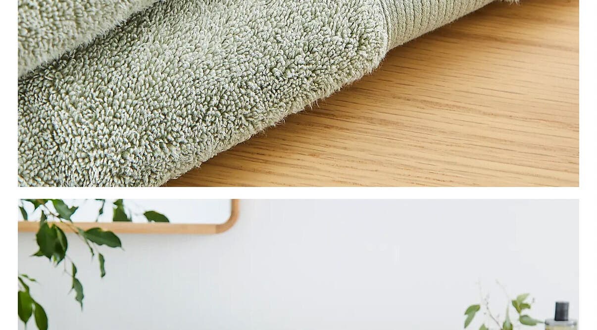Soft green towels on wooden table at Kate’s massage in Castleford, England, GB, creating a tranquil atmosphere.