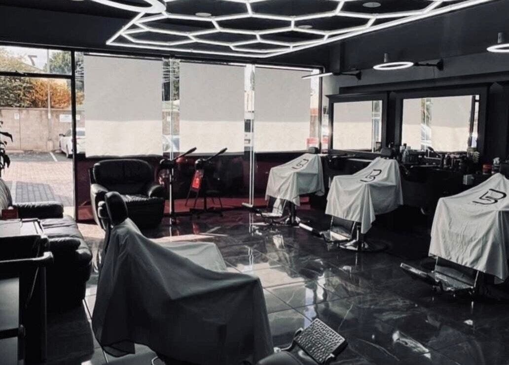 Stylish interior of Romeros Barber Studio in Tijuana, Baja California, MX with modern barber chairs and sleek design.