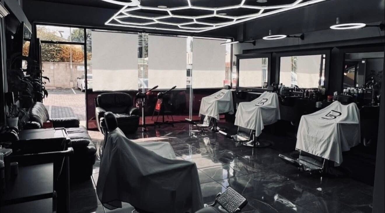 Stylish interior of Romeros Barber Studio in Tijuana, Baja California, MX with modern barber chairs and sleek design.