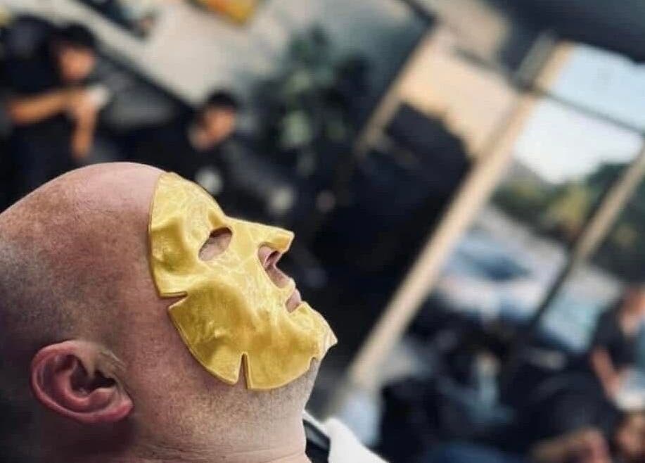 Client enjoys a rejuvenating gold facial mask at Romeros Barber Studio, Tijuana, Baja California, MX.