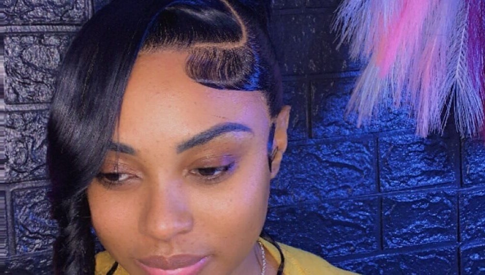 Elegant hairstyle at SamSassyHair, Kingston, St. Andrew Parish, JM, showcasing intricate braid and sleek style.