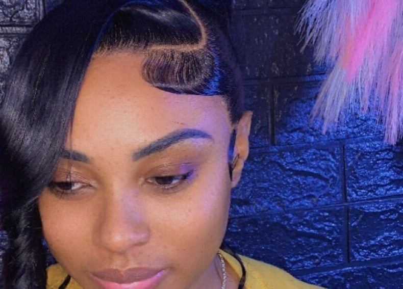 Elegant hairstyle at SamSassyHair, Kingston, St. Andrew Parish, JM, showcasing intricate braid and sleek style.