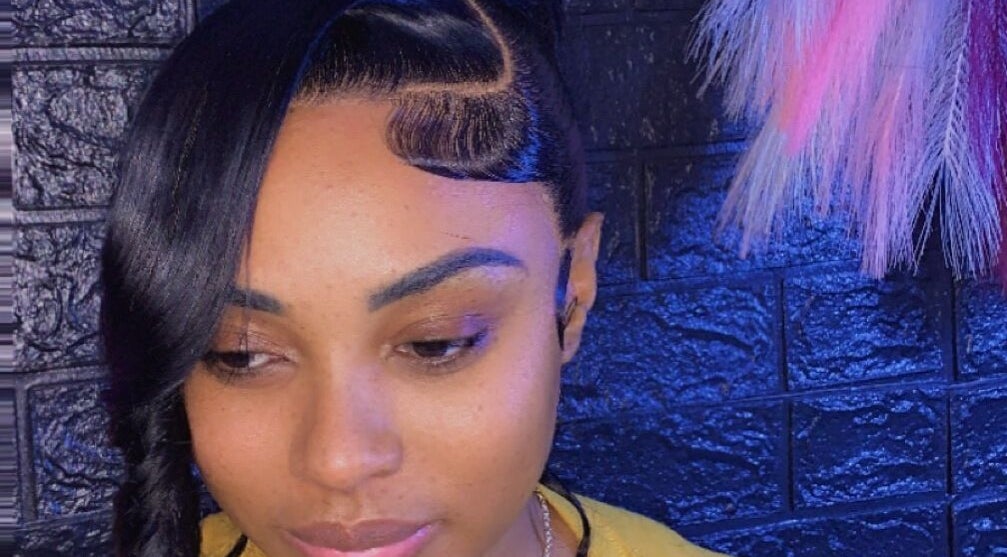 Elegant hairstyle at SamSassyHair, Kingston, St. Andrew Parish, JM, showcasing intricate braid and sleek style.