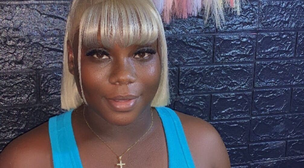 Smiling woman with blonde hair at SamSassyHair, Kingston, St. Andrew Parish, JM.