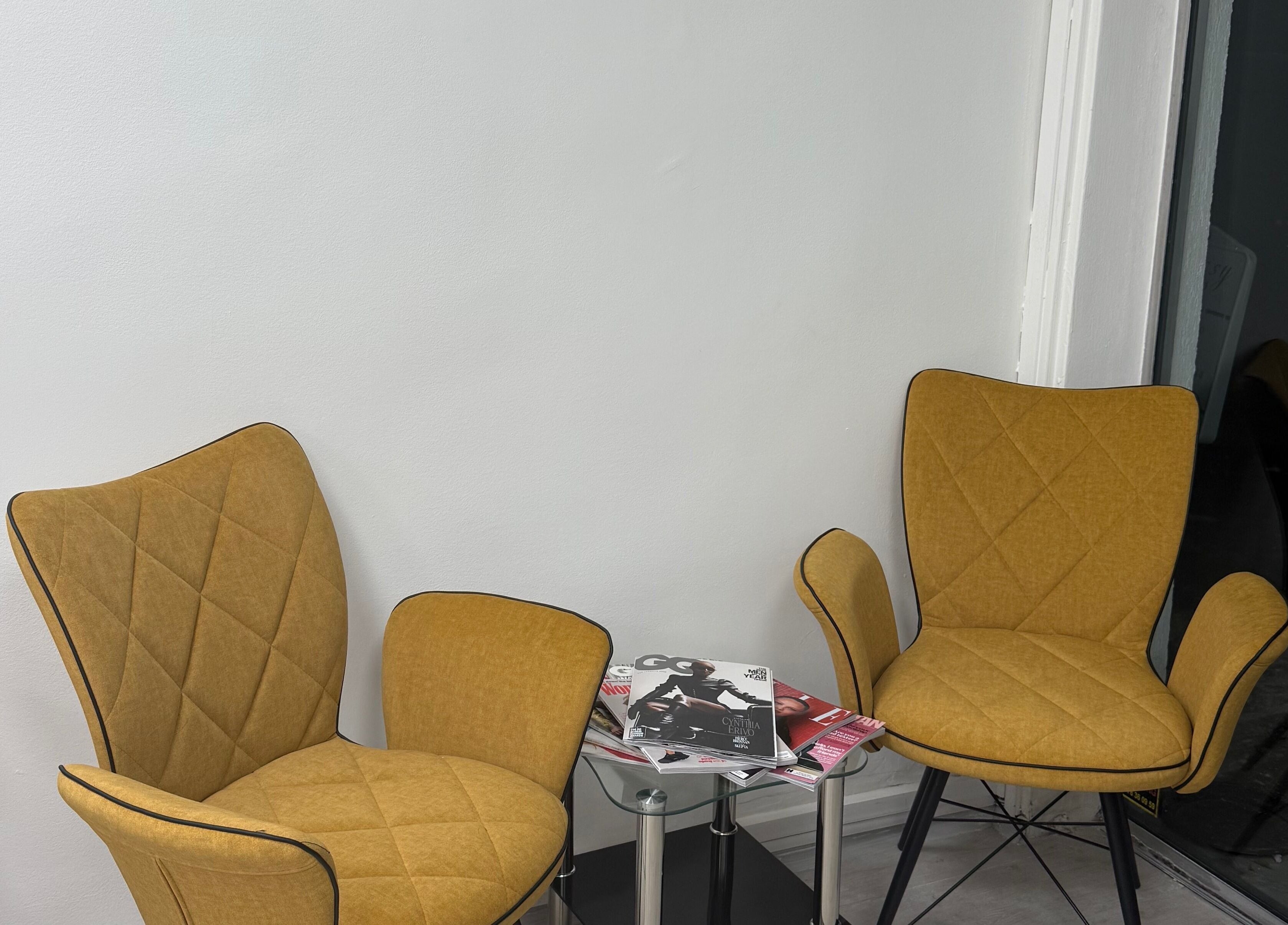 Stylish seating area at MM HAIR STUDIO, Sofia, Sofia, BG, featuring modern chairs and magazines.