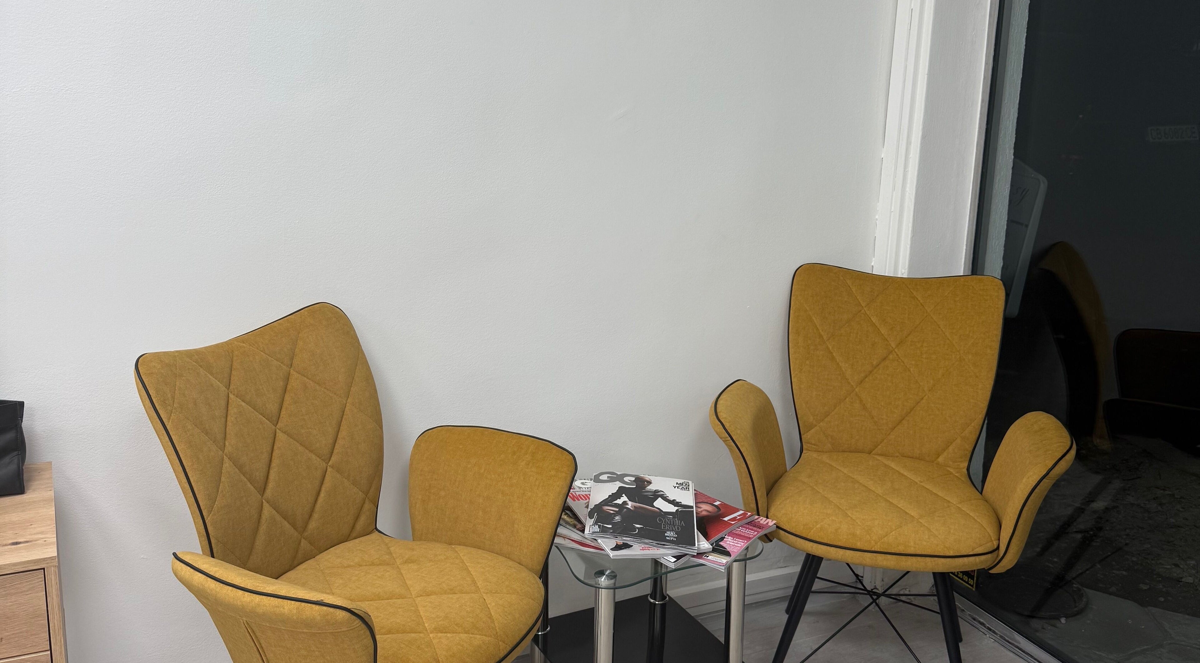 Stylish seating area at MM HAIR STUDIO, Sofia, Sofia, BG, featuring modern chairs and magazines.