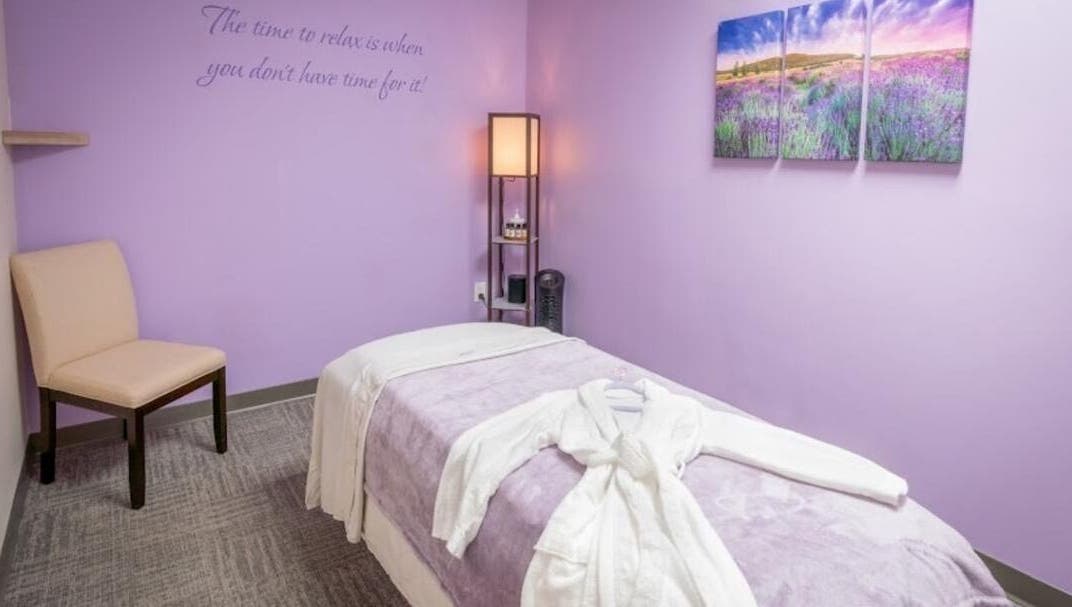 Tranquil massage room with lavender hues at Serenity Haven Spa, Schenectady, New York, US.