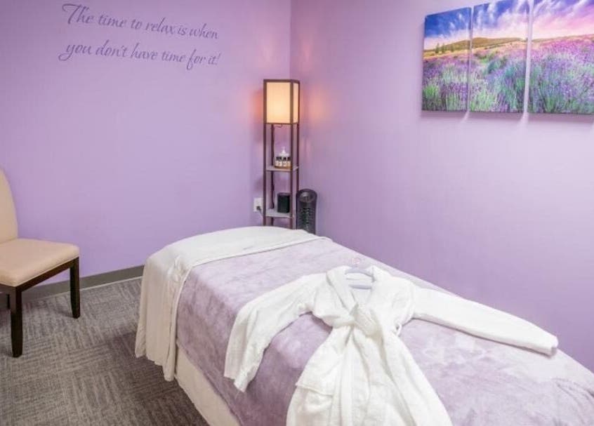 Tranquil massage room with lavender hues at Serenity Haven Spa, Schenectady, New York, US.