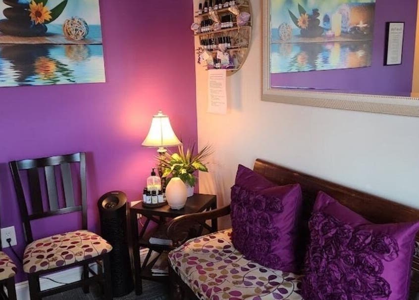Cozy waiting area at Serenity Haven Spa in Schenectady, New York, US, featuring purple decor and soothing ambiance.