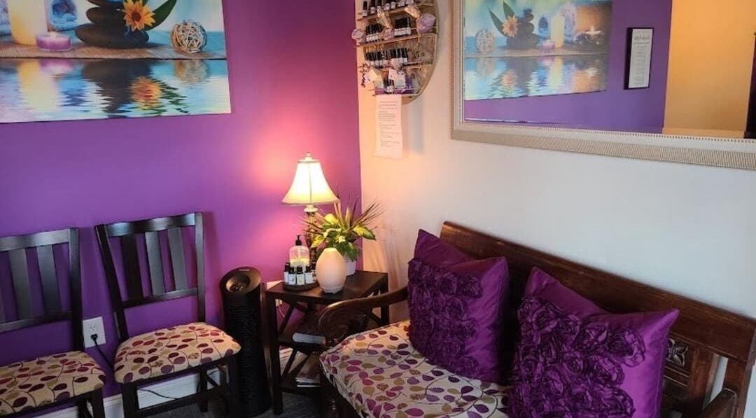 Cozy waiting area at Serenity Haven Spa in Schenectady, New York, US, featuring purple decor and soothing ambiance.