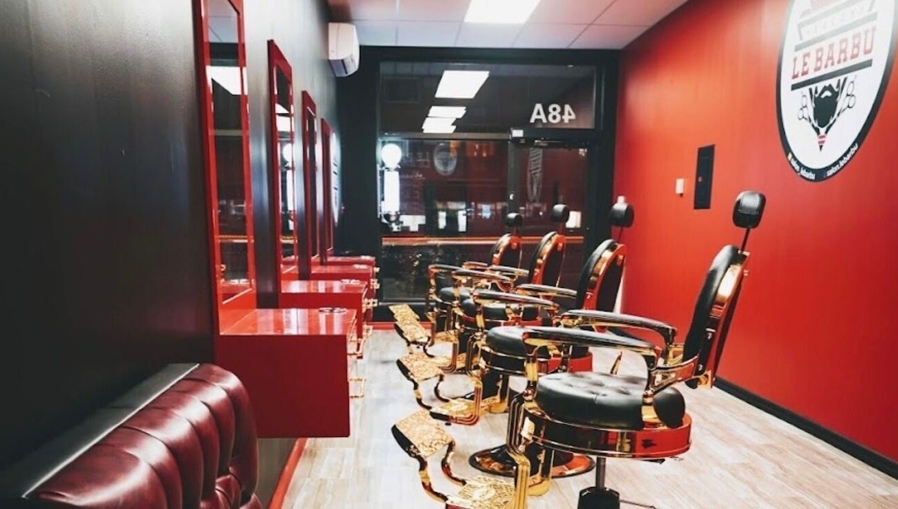 Elegant barber chairs at Le Barbu Henri-Bourassa, Montréal, Québec, CA, showcasing luxury grooming ambiance.
