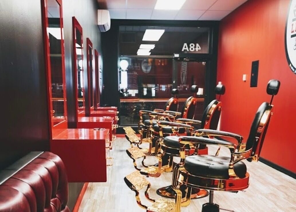 Elegant barber chairs at Le Barbu Henri-Bourassa, Montréal, Québec, CA, showcasing luxury grooming ambiance.