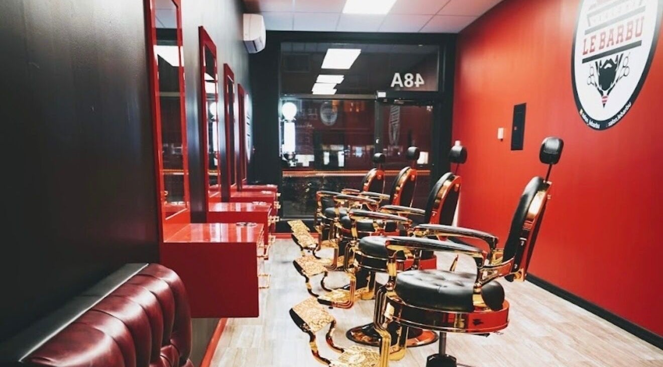 Elegant barber chairs at Le Barbu Henri-Bourassa, Montréal, Québec, CA, showcasing luxury grooming ambiance.