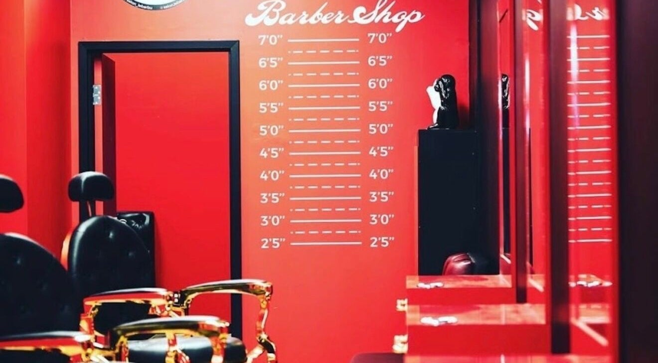 Sleek barber shop interior at Le Barbu Henri-Bourassa, Montréal, Québec, CA with vibrant red decor.
