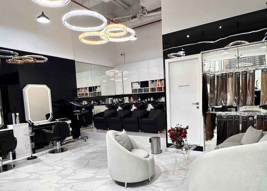 Modern interior of Lul Beauty Salon in Dubai, Dubai, AE featuring sleek styling stations and cozy seating.