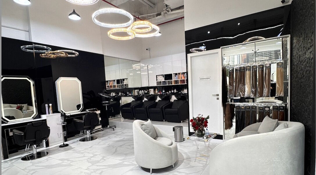 Modern interior of Lul Beauty Salon in Dubai, Dubai, AE featuring sleek styling stations and cozy seating.