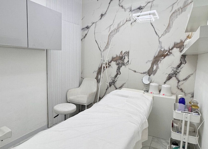Sleek treatment room at Lul Beauty Salon, Dubai, Dubai, AE, featuring modern decor and a cozy therapy bed.