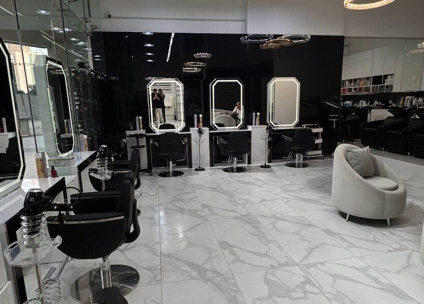 Modern interior of Lul Beauty Salon in Dubai, Dubai, AE with sleek styling chairs and illuminated mirrors.