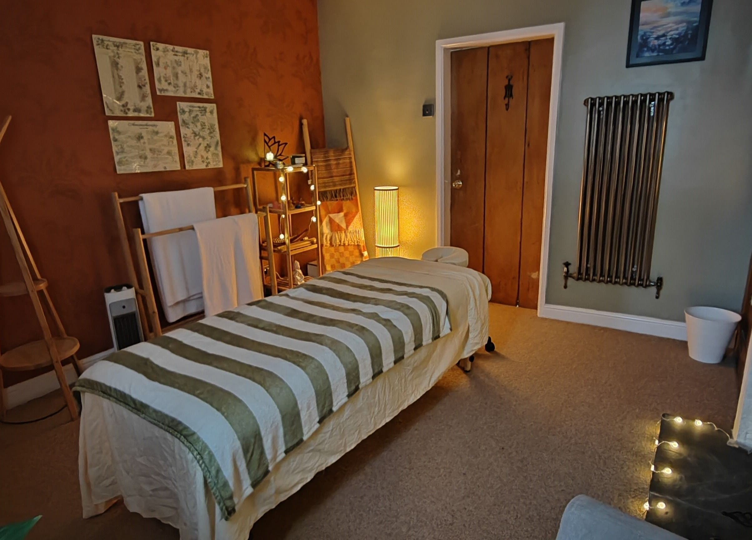 Relaxing massage room at Metta Massage Therapies, Galgate, England, GB with warm lighting and cozy ambiance.