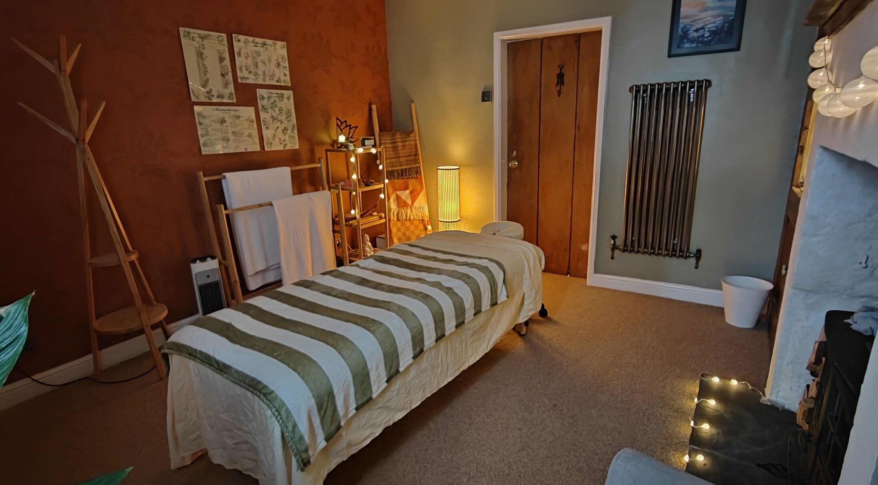 Relaxing massage room at Metta Massage Therapies, Galgate, England, GB with warm lighting and cozy ambiance.