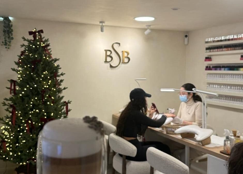 Cozy nail care at Brazilian Soul Beauty, London, England, GB, with festive decor and skilled nail technicians.