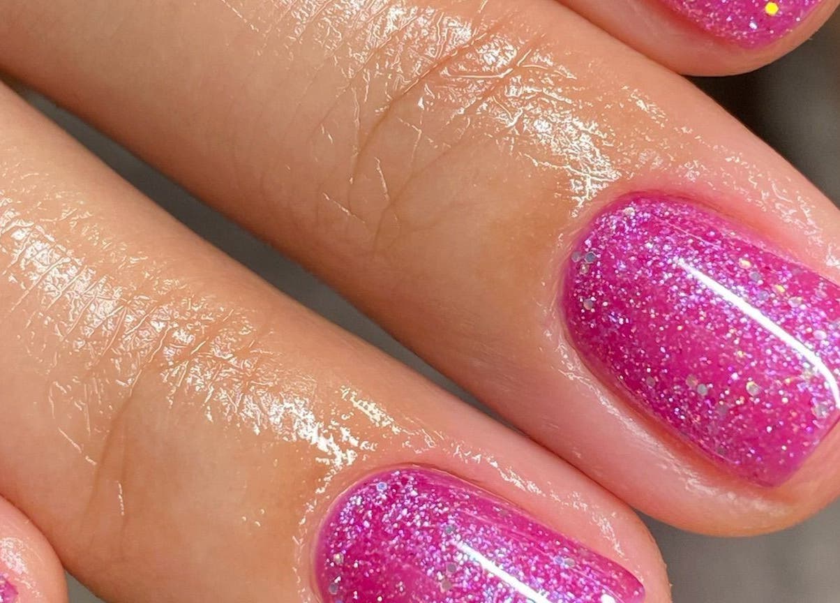 Vibrant pink glitter nails at Brazilian Soul Beauty, London, England, GB. Perfect manicure for any occasion.