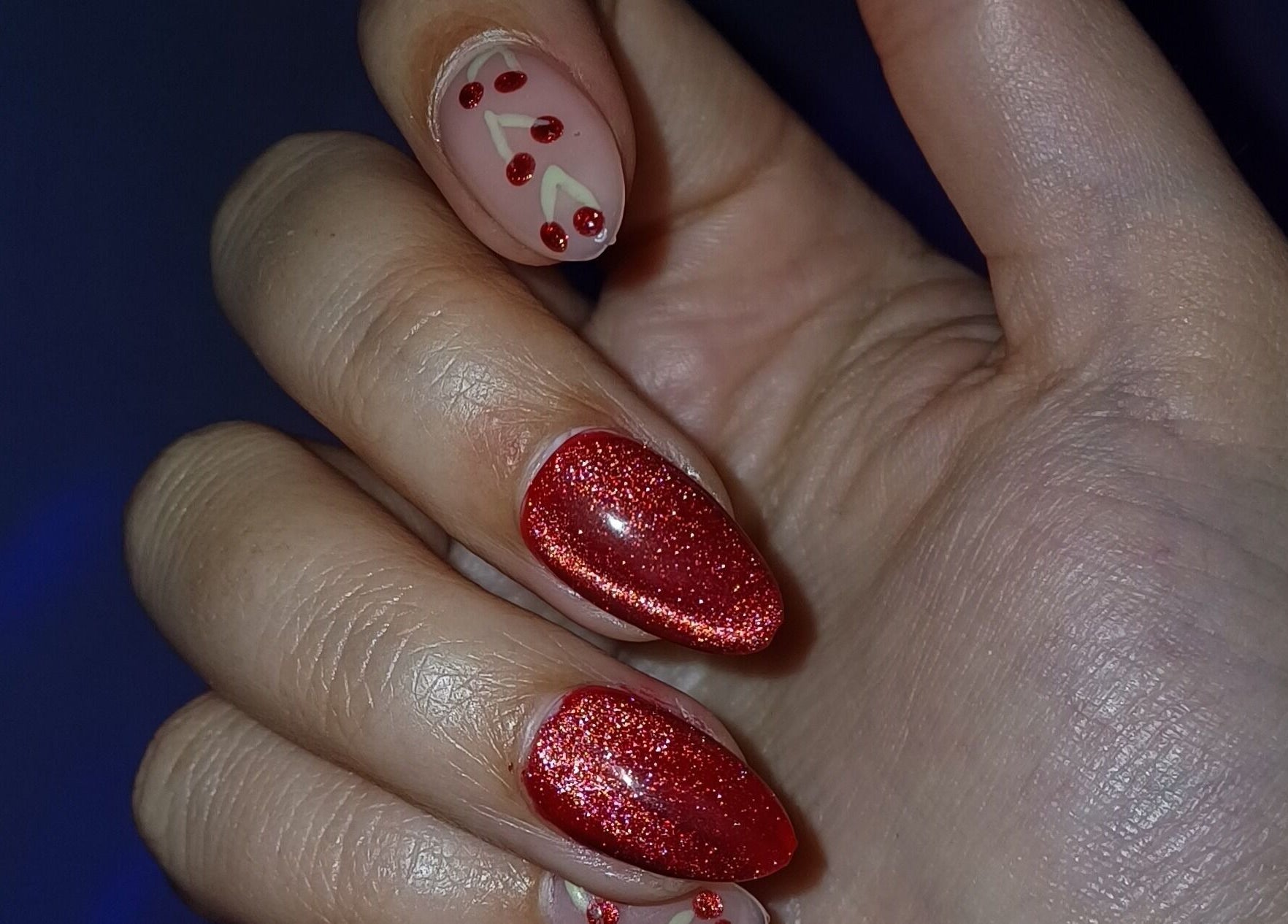 Red glittery manicure at Beauty To Inspire, Boksburg, Gauteng, ZA showcasing festive nail art.