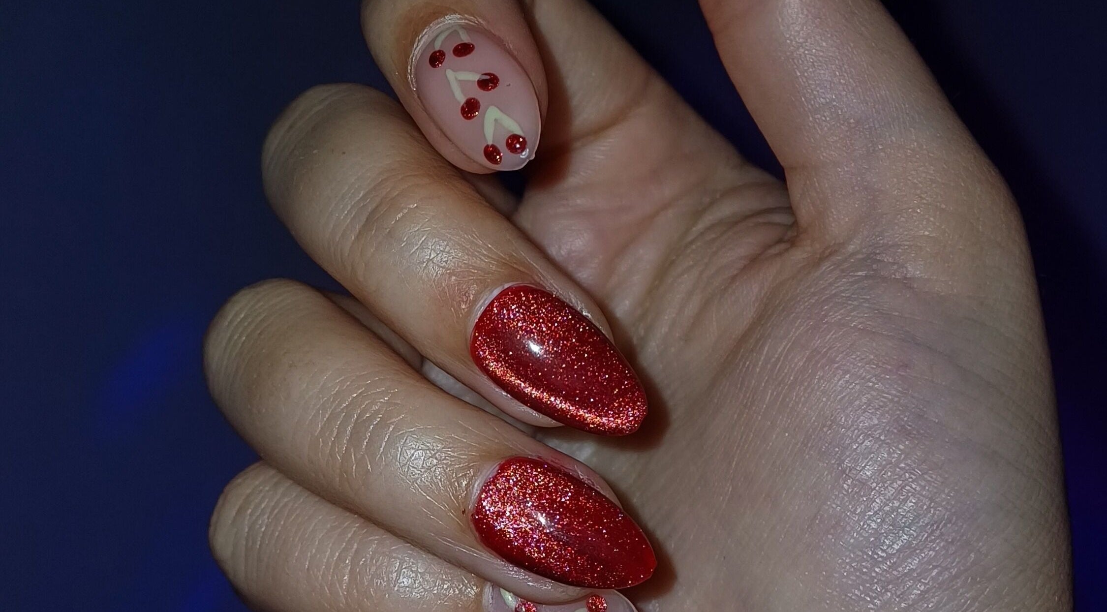 Red glittery manicure at Beauty To Inspire, Boksburg, Gauteng, ZA showcasing festive nail art.