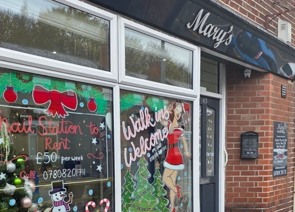 Festive window display at V Beauty World Ltd in Warrington, England, GB invites walk-ins and nail station rental.
