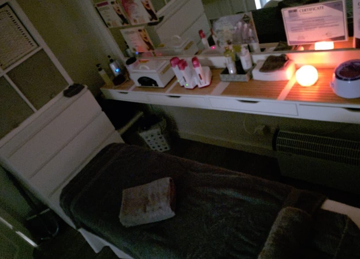 Relaxing treatment room at V Beauty World Ltd, Warrington, England, GB, featuring a cozy bed and ambient lighting.