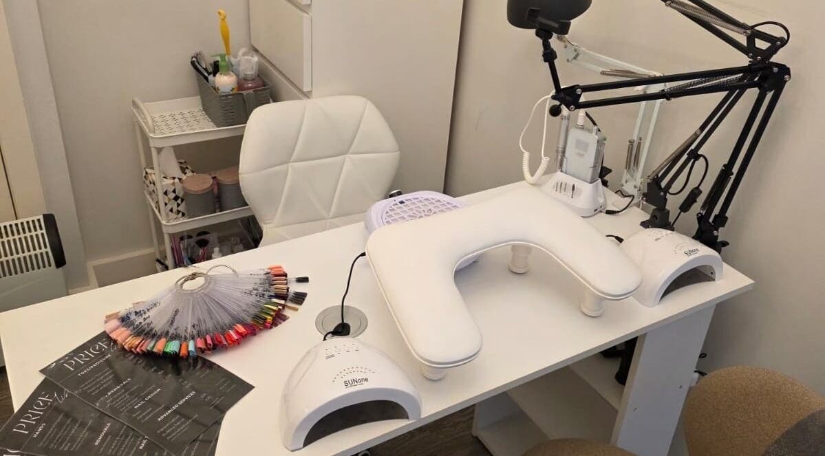 V Beauty World Ltd nail station in Warrington, England, GB, showcasing manicure tools and polish selection.