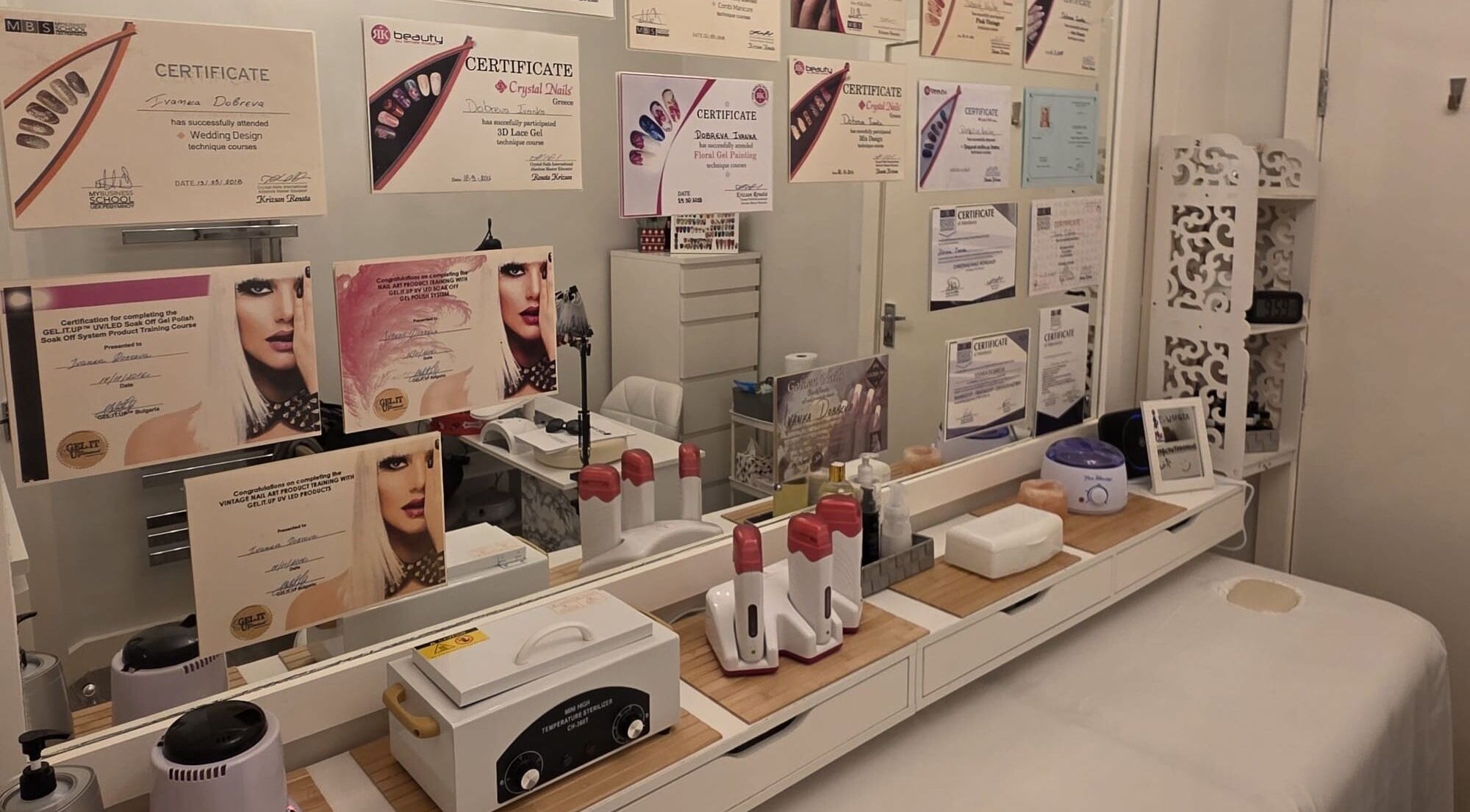 Interior of V Beauty World Ltd, Warrington, showcasing certificates on a mirrored wall with beauty tools.