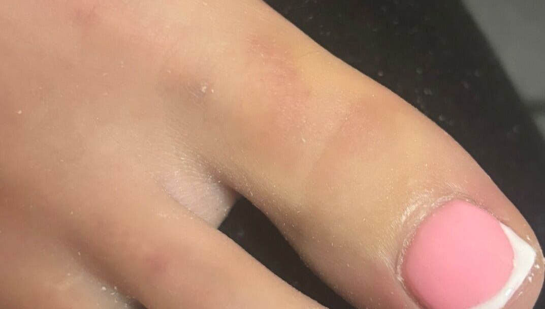 Close-up of elegant pink manicured nails at biabsbymil, GB, showcasing professional nail art.