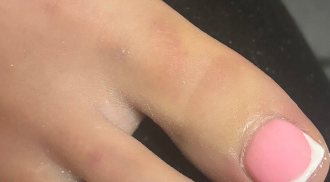 Close-up of elegant pink manicured nails at biabsbymil, GB, showcasing professional nail art.