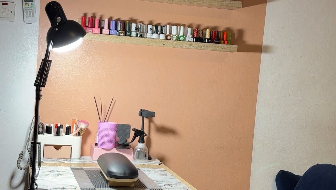 Nail care setup at DEAREST BEAUTY STUDIO, Lagos, Lagos, NG with polishes and tools on a sleek desk.
