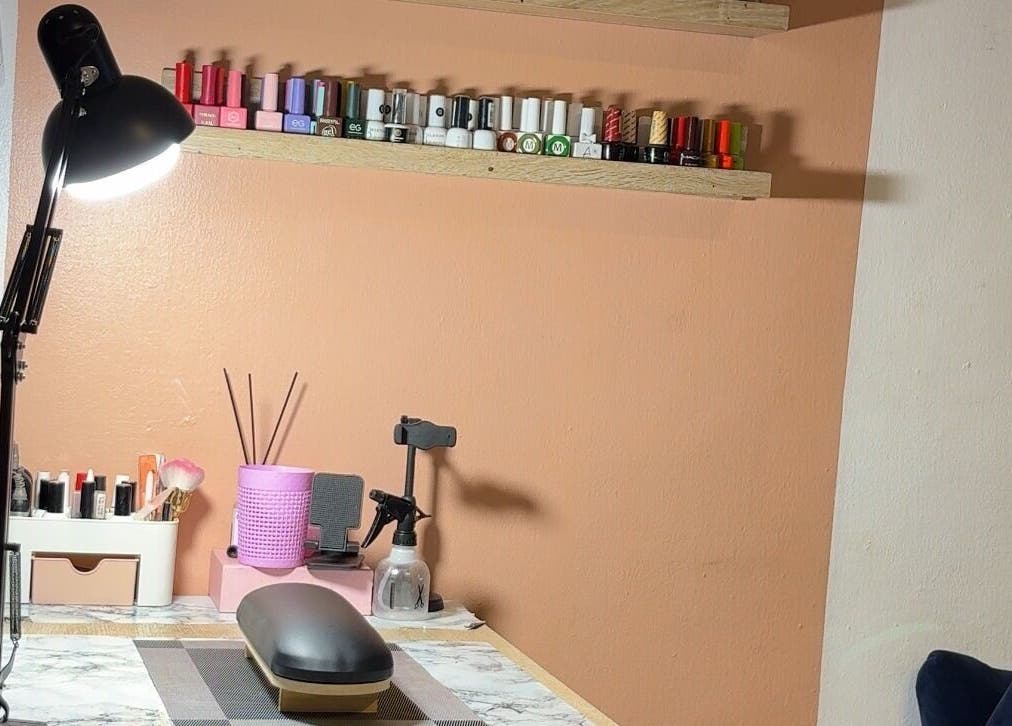 Nail care setup at DEAREST BEAUTY STUDIO, Lagos, Lagos, NG with polishes and tools on a sleek desk.