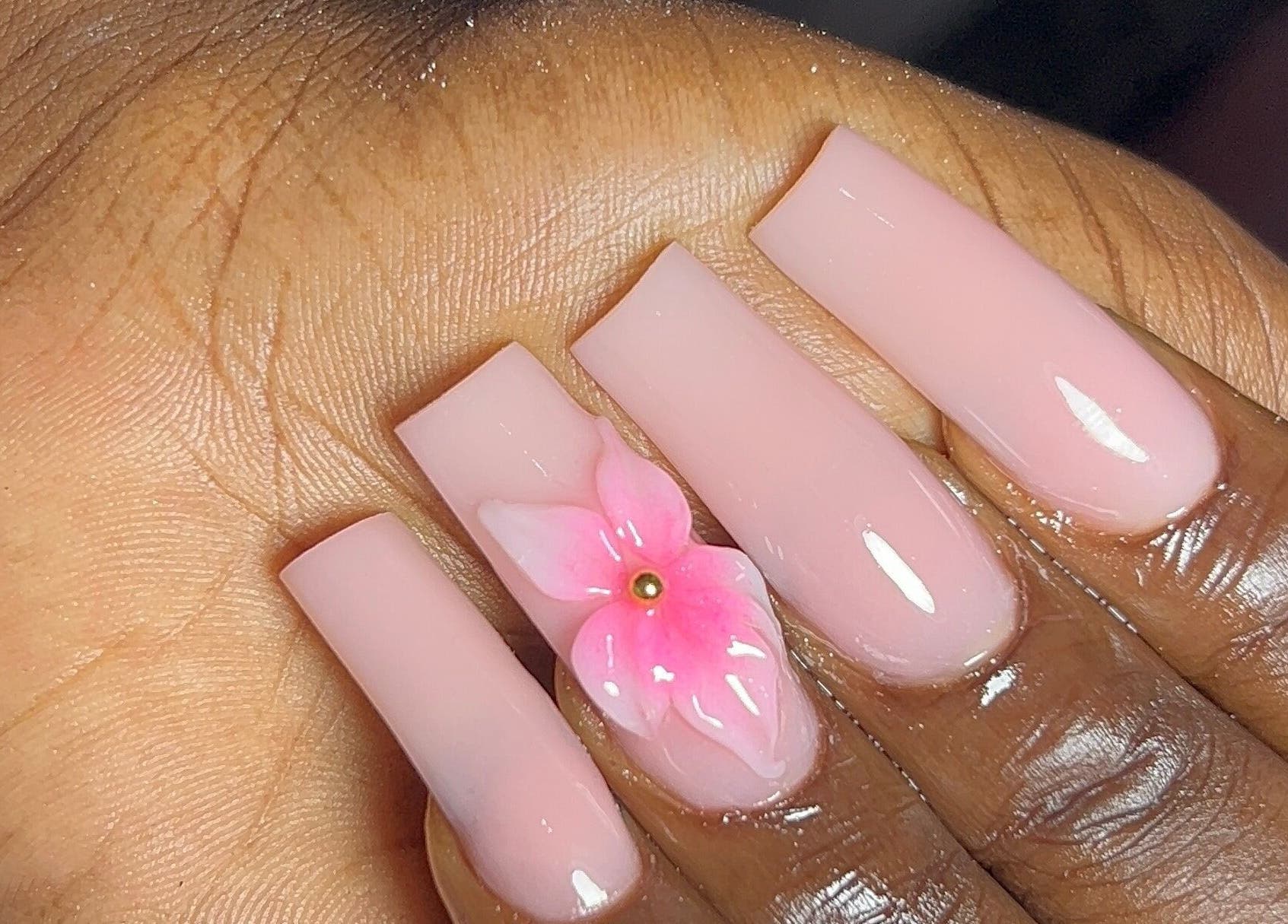 Elegant pink nails with floral design at DEAREST BEAUTY STUDIO, Lagos, Lagos, NG.